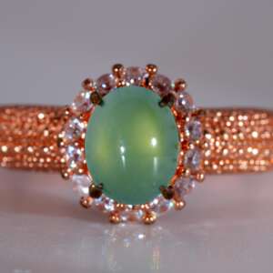 Front view of Type-A jadeite jade ring with light apple-green cabochon and rose-gold pavé band, size 8
