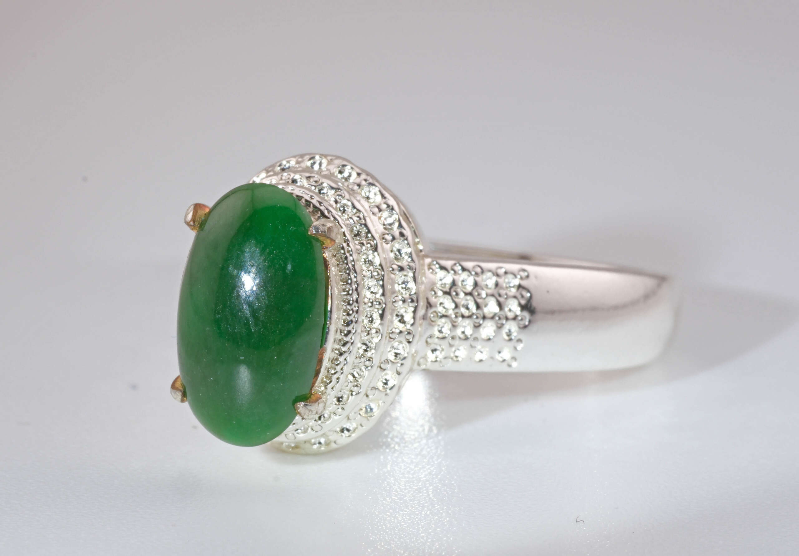 Side profile of the jadeite jade ring highlighting the raised setting and bead-patterned silver design