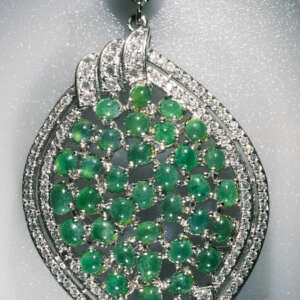 Convertible pendant and brooch featuring natural A-type jadeite cabochons set in a mixed alloy, measuring 5 by 3.5 cm and weighing 14.067 grams.