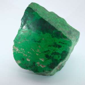 Containing a rare mineral called kosmochlor, maw sit sit rough jade rocks are bright green and dense with minerals including jadeite